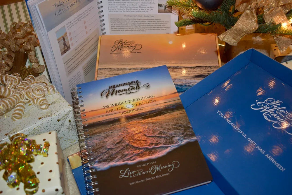 Two spiral-bound books on a table with decorative items in the background