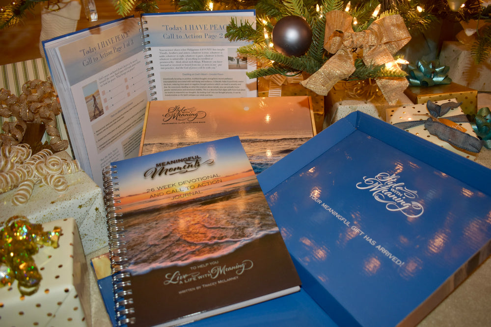 26 Week Devotional book and gift box surrounded with gifts and a lighted tree. 